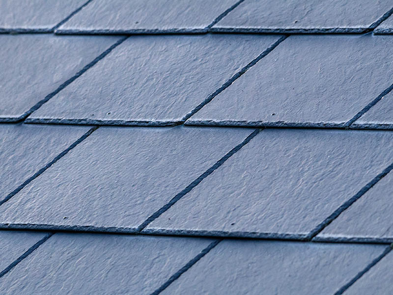 Closeup of synthetic slate tiles on a roof.