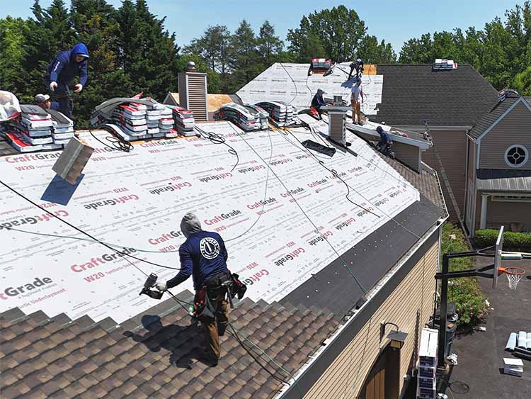 AC Matthews roofers working on a complete roof replacement.