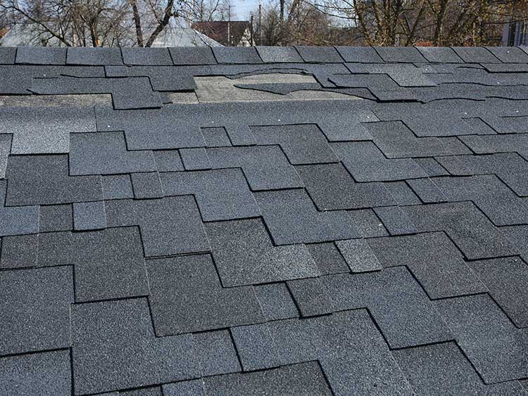 Multiple missing shingles on roof.