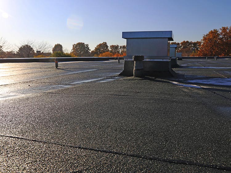 Newly installed modified bitumen flat roofing system.