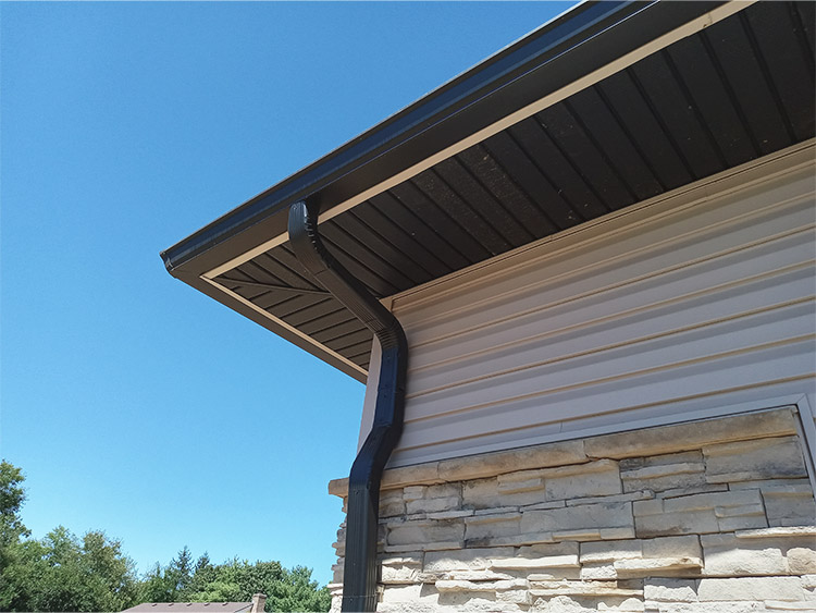 Black, modern gutter system on residential home.