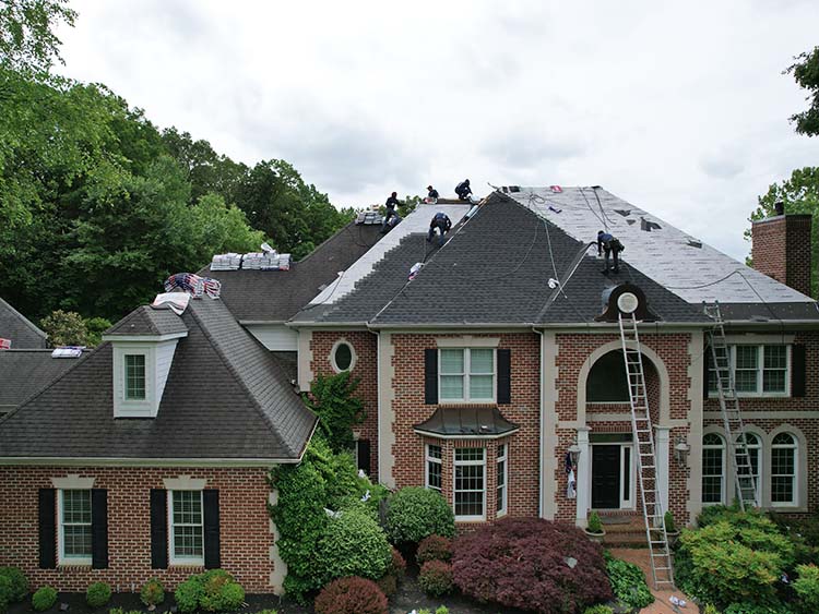 Roofers replacing a residential roof.