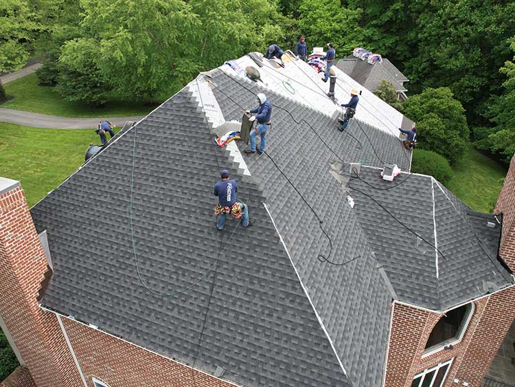 AC Matthews roofing crew working on a residential roof.