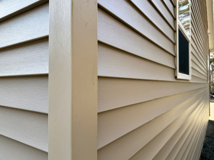 New beige color siding on residential house.