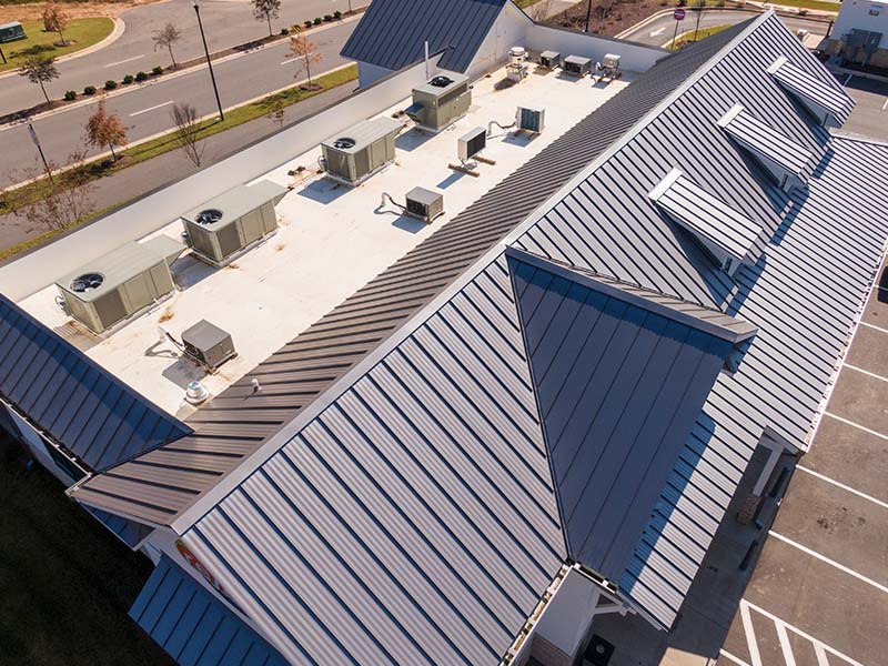 Business building with a combination of metal roofing and flat roofing.