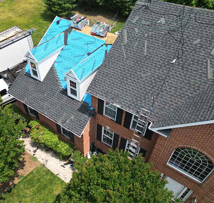 Shingle roof replacement in progress on a residential home.