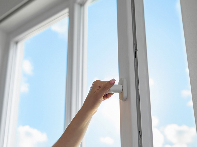 Woman opening a window.