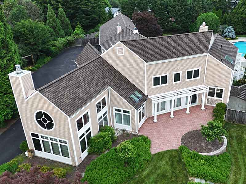 Residential home with new GAF Timberline UHDZ shingle roof installed by AC Matthews.