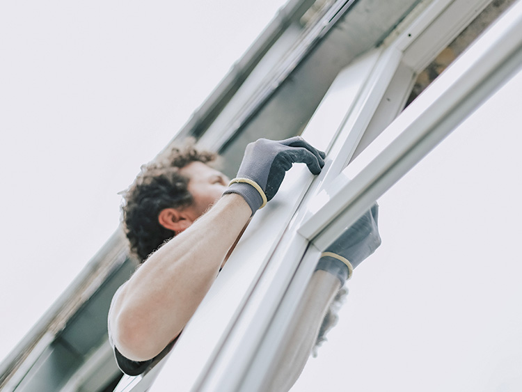 Technician replacing residential window.
