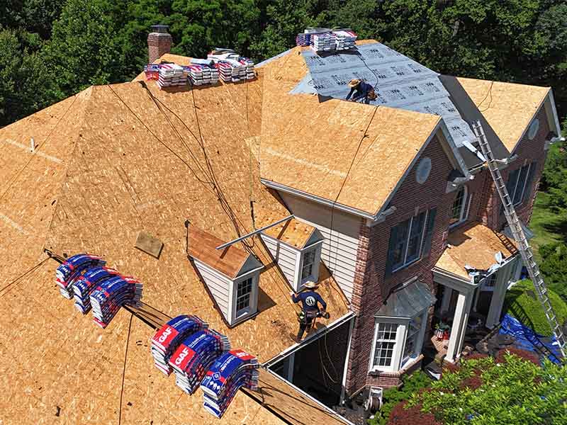 AC Matthews roofing crew working on a roof replacement.